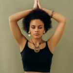 A woman in a yoga pose with closed eyes, symbolizing tranquility and self-awareness.