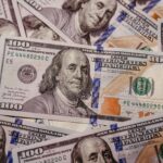 Stack of 100 dollar US banknotes with Benjamin Franklin portrait.